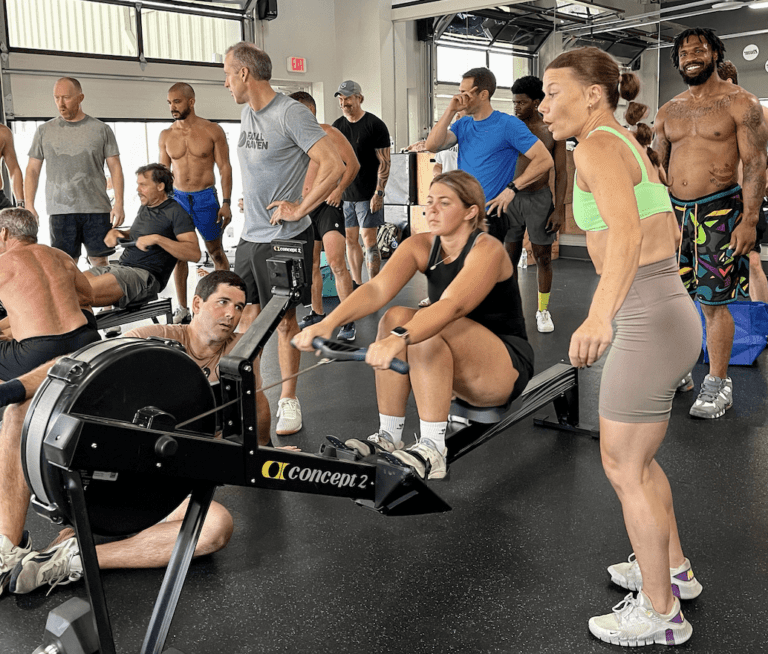 people watching woman rowing at Survivor Fitness Fundraising Event