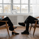 Two people sitting in chairs discussing anxiety.