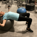 Pamela wilson working out on an exercise ball.