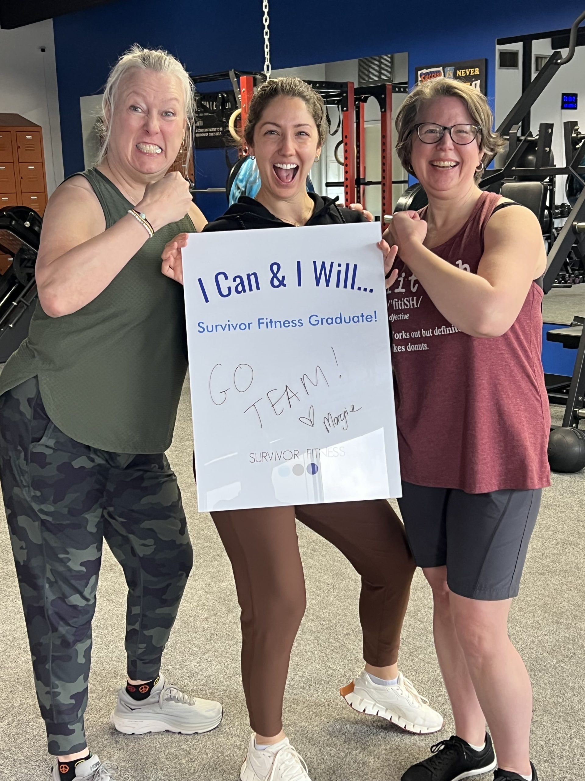 survivor fitness participants holding an I can and I will sign