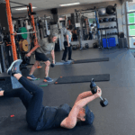 women working out lifting weights in a gym
