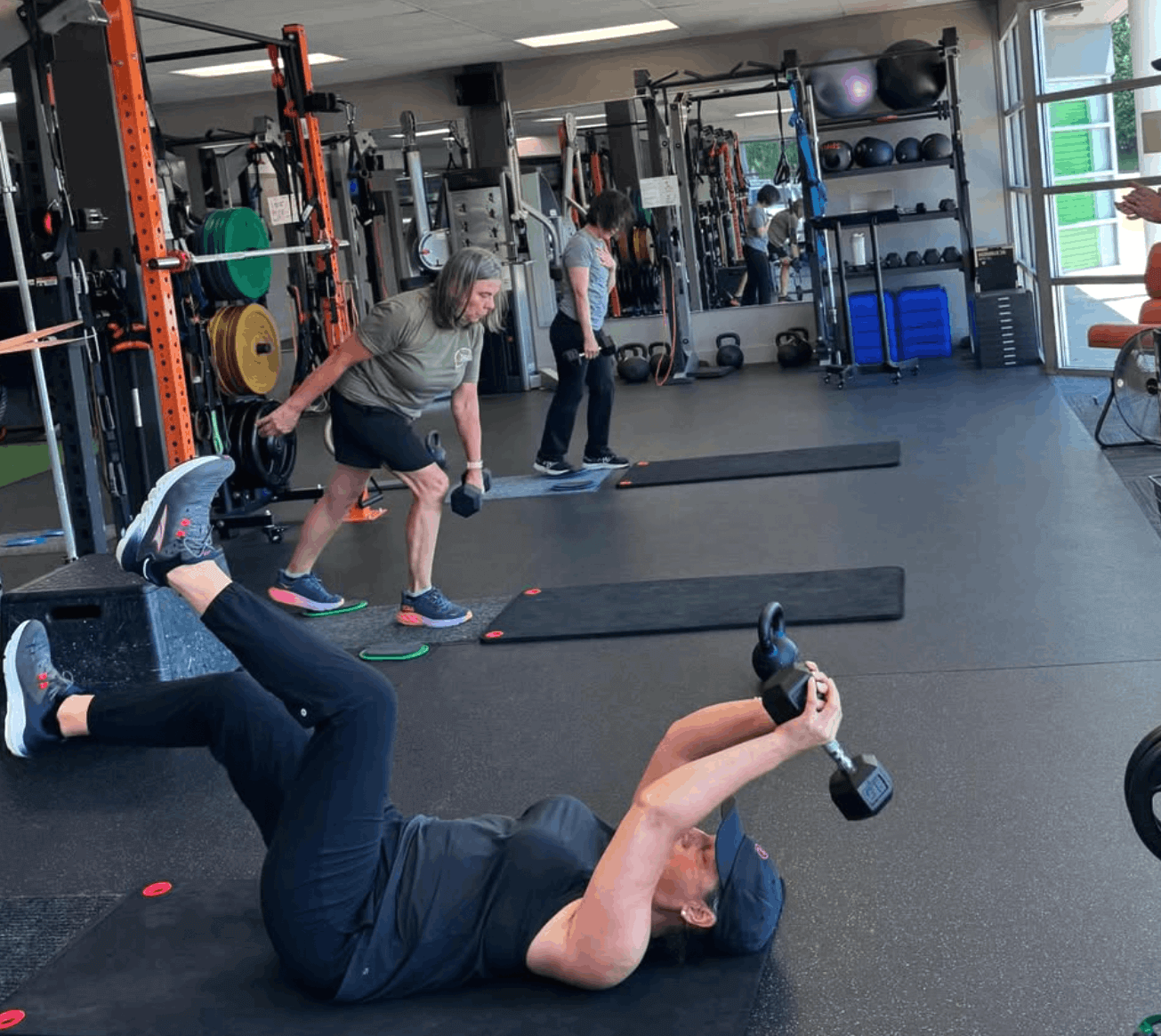 women working out lifting weights in a gym