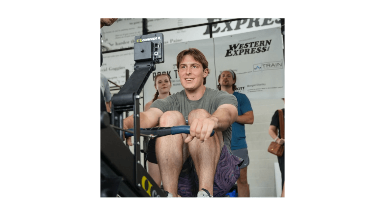 man using rowing machine at gym