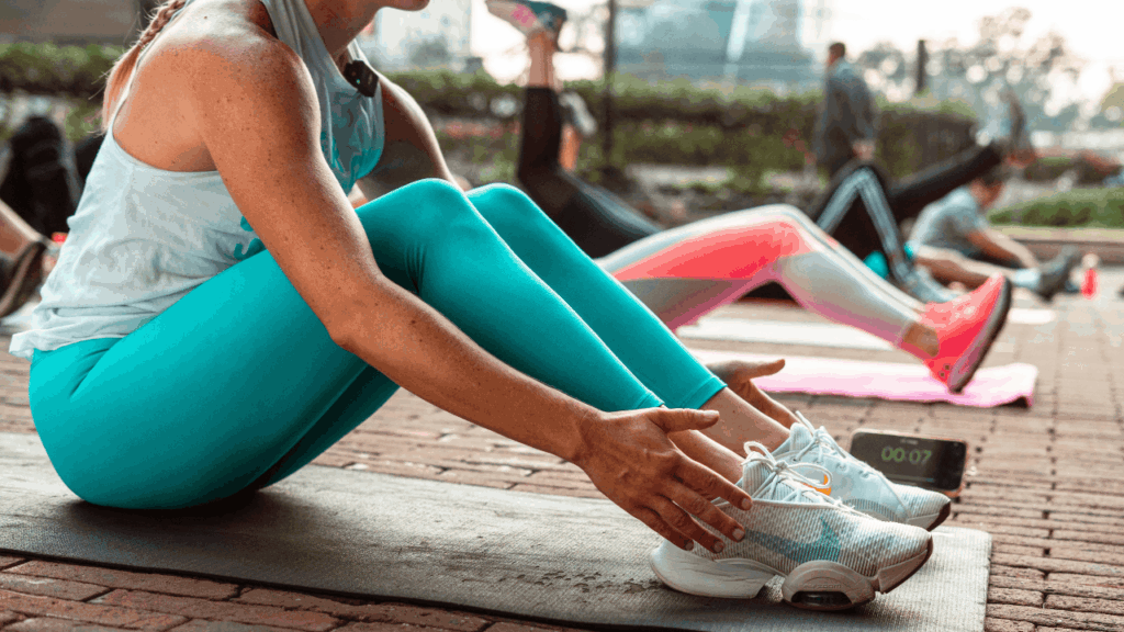 women on yoga mats stretching in a class