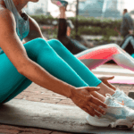 women on yoga mats stretching in a class
