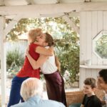 women hugging among family